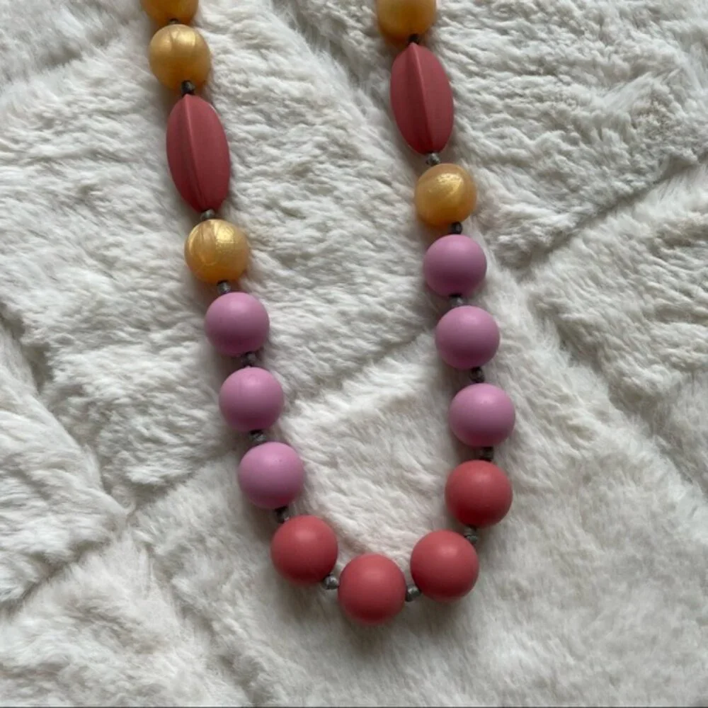 Itzy Ritzy | Teething Happens Chewable Mom Necklace | Pink & Gold